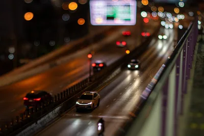 Night Highway Traffic with Bokeh Lights and Digital Display - free city & urban wallpaper 5568×3712