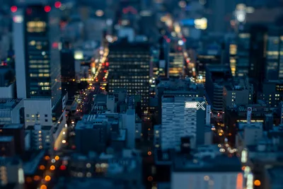 Night City Skyline with Tilt-Shift Effect and Hotel Sign - free city & urban wallpaper 5568×3712