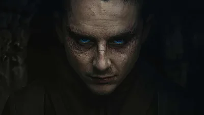 Portrait Of A Man With Glowing Blue Eyes In Darkness - free wallpaper 3840×2160