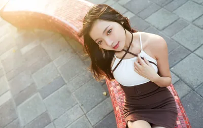 Young Woman Posing Outdoors on Paved Ground - free wallpaper 5177×3261