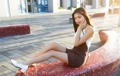 Young Woman Posing on Red Brick Bench in Urban Plaza - free people & portraits wallpaper 4817×3034