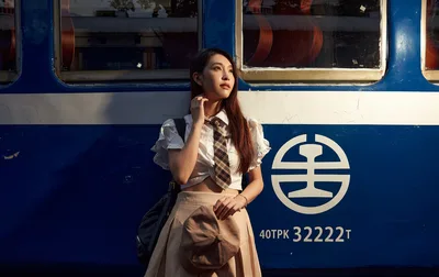 Young Woman Posing Against Blue and White Train - free people & portraits wallpaper 5029×3167
