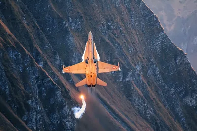 Orange Fighter Jet Flying Through Mountain Canyon - free cars & vehicles wallpaper 4288×2848