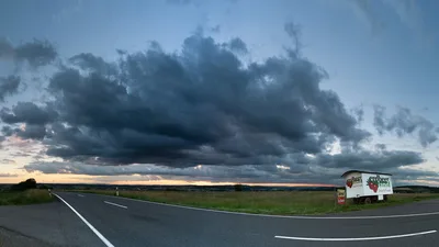 Rural Highway with Storm Clouds and Roadside Stand - free landscapes wallpaper 9975×5611