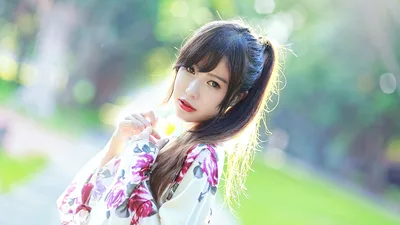 Young Woman in Floral Áo Dài with Blurred Garden Background - free wallpaper 5760×3240