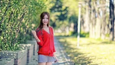 Young Woman in Red Cardigan on Tree-Lined Path - free wallpaper 5760×3240
