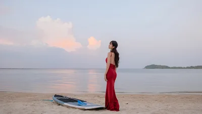 Woman in Red Dress Standing on Beach at Sunset - free wallpaper 6000×3376