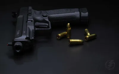 Black Handgun With Golden Ammunition on Dark Surface - free architecture wallpaper 3840×2400