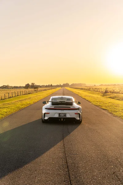 White Sports Car on Rural Asphalt Road at Sunset - free cars & vehicles wallpaper 6336×9504