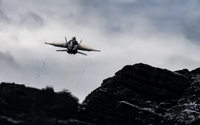 Military Jet Fighter Flying Over Rocky Mountain Terrain - free cars & vehicles wallpaper 5011×3132
