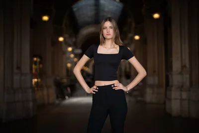 Woman in Black Crop Top Posing in Lit Arcade Corridor - free people & portraits wallpaper 5878×3919