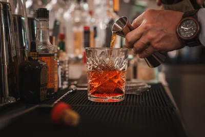 Bartender Pouring Whiskey Into Crystal Glass at Bar - free food wallpaper 4165×2782