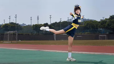 Cheerleader Performing High Kick on Sports Field - free people & portraits wallpaper 5182×2915
