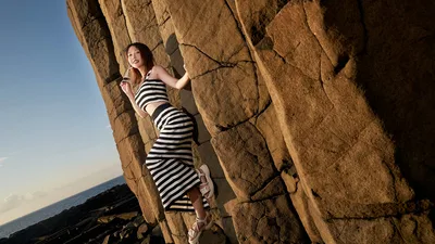 Woman in Striped Dress Posing Against Coastal Rock Formation - free people & portraits wallpaper 5184×2915