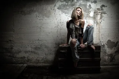 Woman Sitting on Wooden Crate Against Deteriorating Wall - free wallpaper 2048×1365