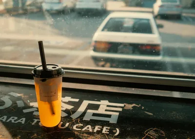 Orange Beverage by Window Overlooking Parked Cars - free cars & vehicles wallpaper 2048×1463