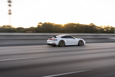 White Porsche 911 GT3 Racing on Highway at Sunset - free cars & vehicles wallpaper 9504×6336
