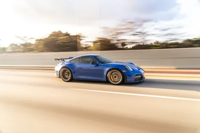 Blue Porsche 911 GT3 Racing on Highway at Speed - free cars & vehicles wallpaper 9504×6336