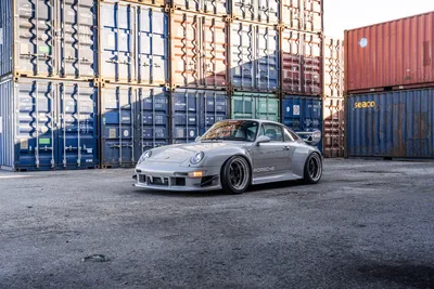 Silver Porsche 911 GT2 Among Stacked Shipping Containers - free cars & vehicles wallpaper 9504×6336