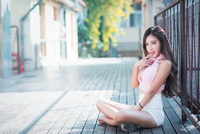 Woman Sitting on Wooden Deck by Metal Fence - free wallpaper 5760×3840