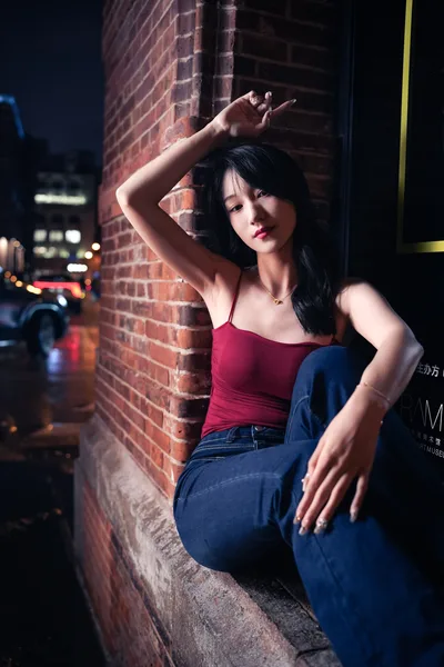 Woman in Red Top and Jeans Against Brick Wall at Night - free people & portraits wallpaper 2731×4096