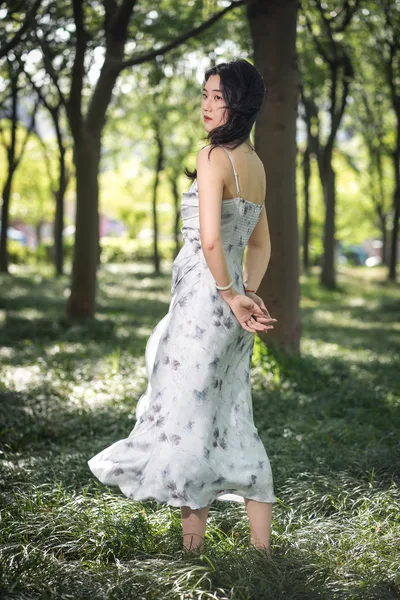 Woman in Floral Dress Posing in Tree-Lined Park - free people & portraits wallpaper 4672×7008