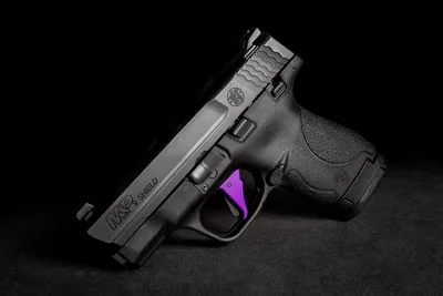 M&P Shield Pistol with Purple Trigger on Black Surface - free weapons wallpaper 2048×1366