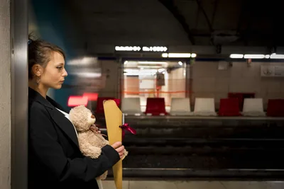 Woman with Teddy Bear Waiting at Train Station - free wallpaper 5912×3941