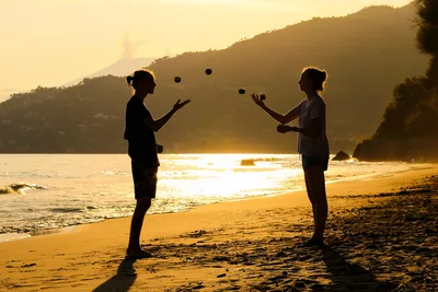 Two Girls Juggling on Beach at Golden Sunset - free wallpaper 5119×3412
