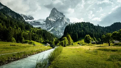 Alpine Valley: Where Mountain Peaks Meet Flowing Waters - free landscapes wallpaper 5120×2880