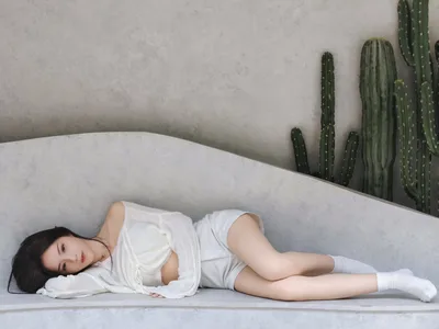 Woman in White Clothing Resting Against Concrete Wall with Cactus - free people & portraits wallpaper 4096×3072