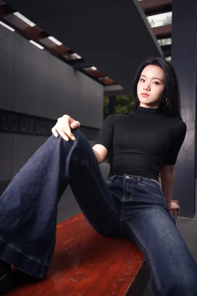 Woman in Black Top and Jeans on Wooden Bench - free wallpaper 4096×6144