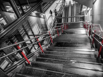 Modern Staircase with Red Railings and Lone Figure - free city & urban wallpaper 4640×3472