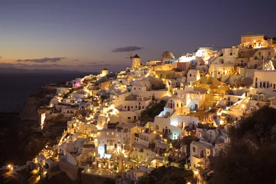 Santorini Village at Twilight with Golden Lights - free city & urban wallpaper 8561×5708