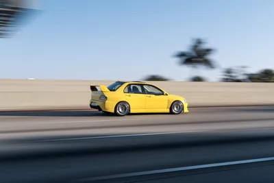 Yellow Sports Car Racing on Highway at High Speed - free cars & vehicles wallpaper 9504×6336