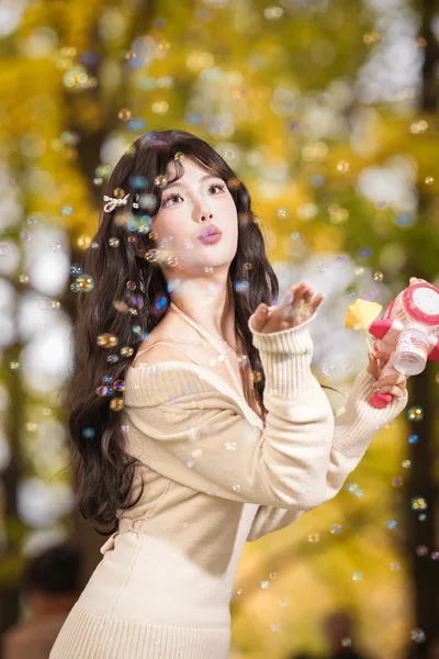 Woman Blowing Bubbles in Autumn Garden - free people & portraits wallpaper 4664×6996