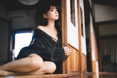 Woman in Black Sweater Sitting by Wooden Door - free people & portraits wallpaper 6000×4000