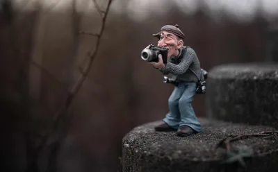 Miniature Photographer Figure on Rocky Terrain - free wallpaper 2400×1488