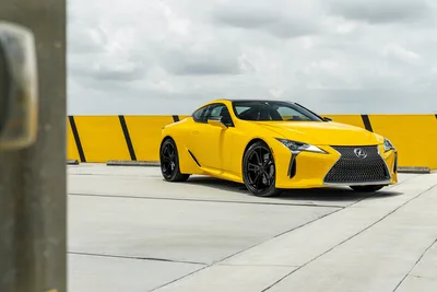 Yellow Lexus LC Sports Car Parked Against Yellow Barrier - free cars & vehicles wallpaper 7878×5256