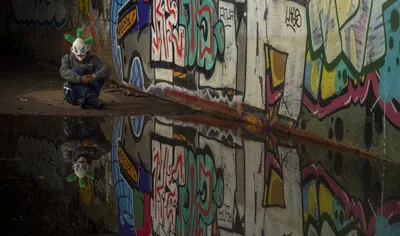 Clown Figure Crouching Before Graffiti Wall With Reflection - free people & portraits wallpaper 4608×2716