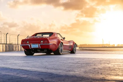 Red Corvette Convertible at Sunset on Industrial Lot - free cars & vehicles wallpaper 9504×6336