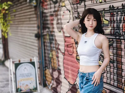 Young Woman in White Tank Top Against Brick Wall - free people & portraits wallpaper 4096×3072
