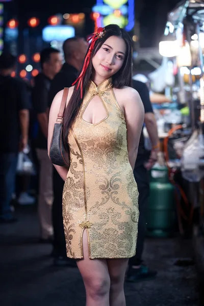 Woman in Gold Cheongsam at Night Street Market - free people & portraits wallpaper 4096×6144