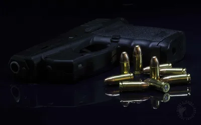 Black Handgun with Brass Ammunition on Dark Surface - free weapons wallpaper 1920×1200