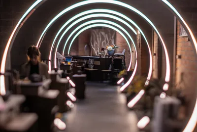 Neon Tunnel Workspace with Focused Creator - free city & urban wallpaper 5568×3712
