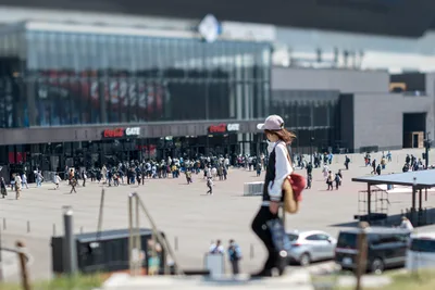 Woman Skateboarding Near Stadium Gate - free city & urban wallpaper 5568×3712