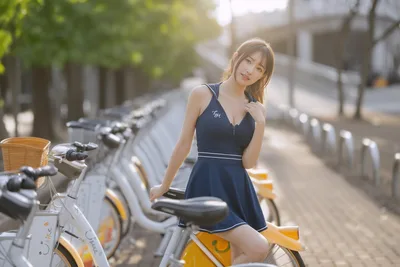 Woman in Navy Dress Posing with Shared Bikes - free people & portraits wallpaper 6144×4096