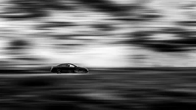 Speed and Silence: Black Sedan in Motion - free wallpaper 5026×2827