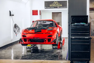 Red Sports Car in Professional Garage Workshop - free cars & vehicles wallpaper 6575×4383