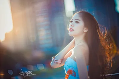 Woman in Blue Floral Top Against City Backdrop - free people & portraits wallpaper 5760×3840